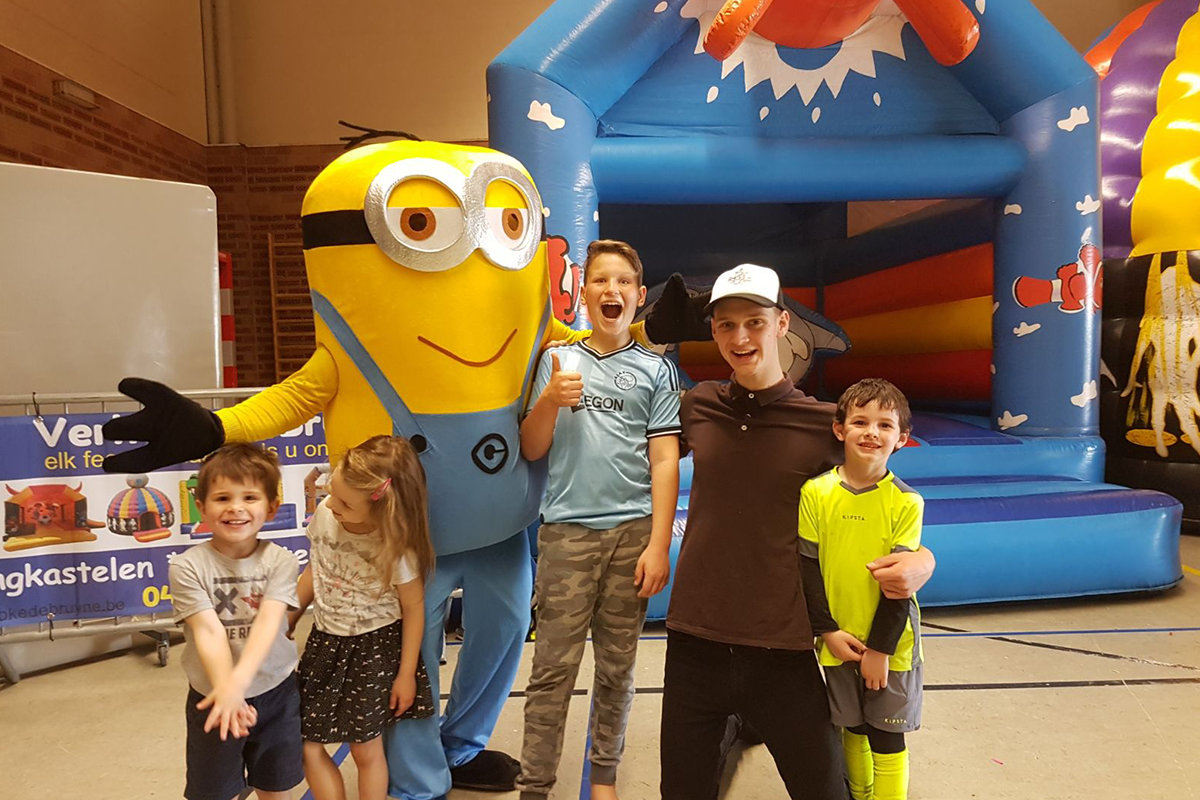 Minion and kids in front of bouncy castle